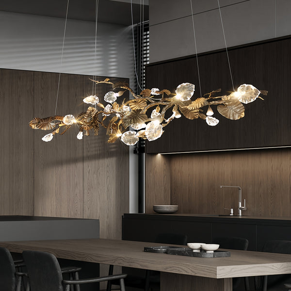 Elegant Lotus chandelier featuring delicate lotus leaf pendants made of transparent material, capturing light with a crystalline shimmer. The slender, organic brass copper branch adds warmth, while the LED lights provide a cool glow. Ideal centerpiece for a sophisticated dining area or tranquil bedroom retreat.