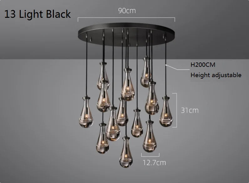 Raine Modern Chandelier with K9 crystal prisms and sleek metal design, perfect for high-ceiling living rooms, foyers, and upscale interiors. Adjustable height, energy-efficient LED compatible.